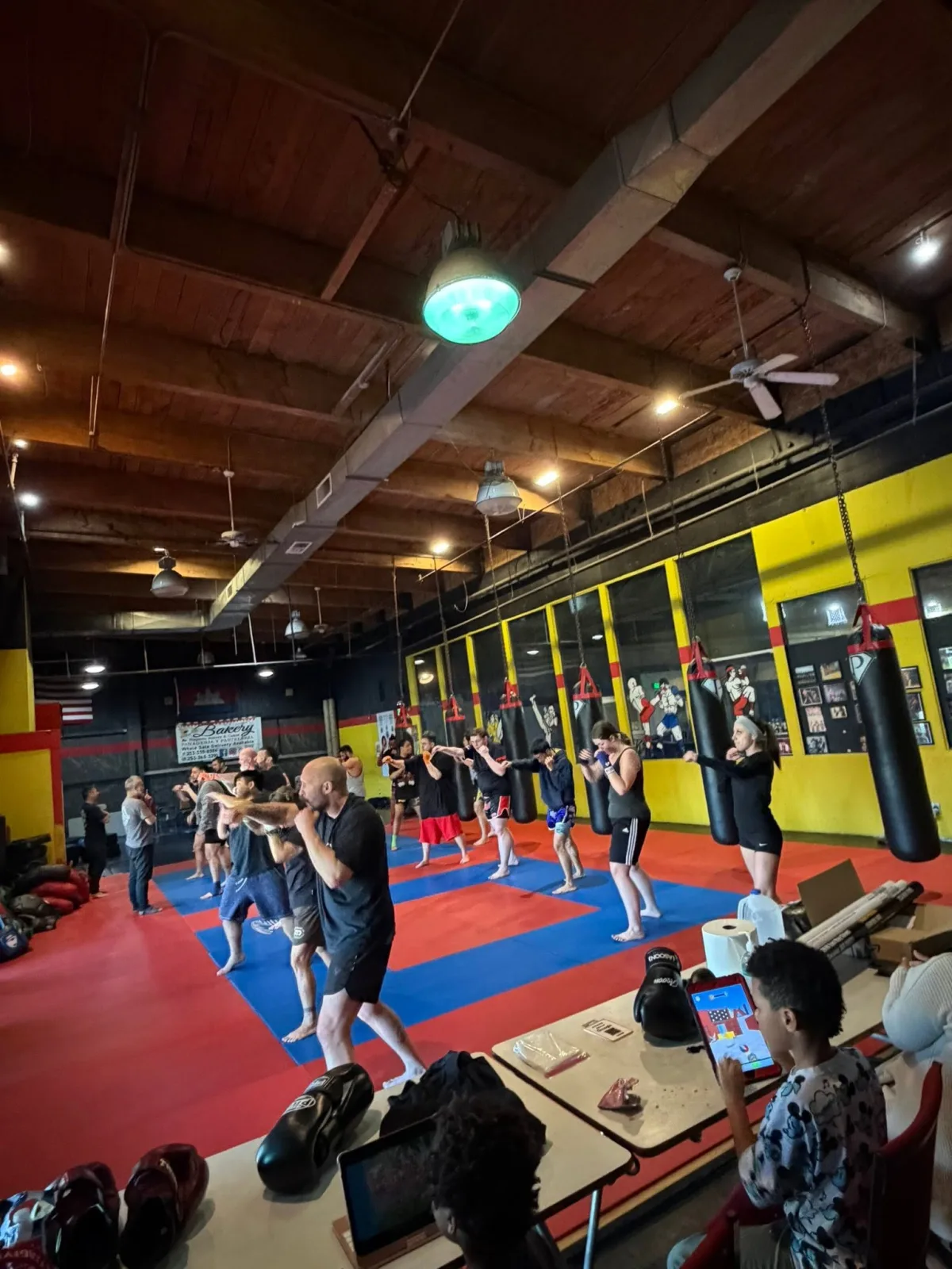 The gym floor seen from above, a full class working through a combination together