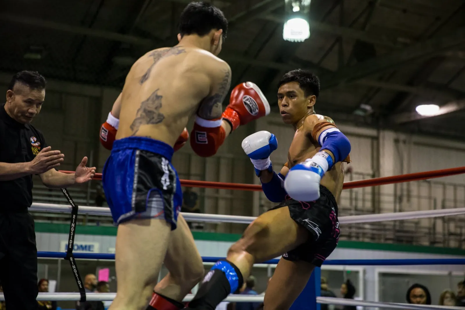 A South Sound fighter lands a switch kick to the body under the referee's watch at a Kun Khmer card