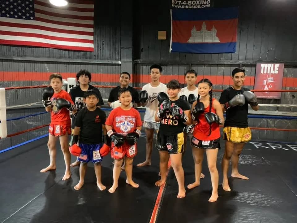 Young South Sound Martial Arts students in the ring beneath the American and Cambodian flags