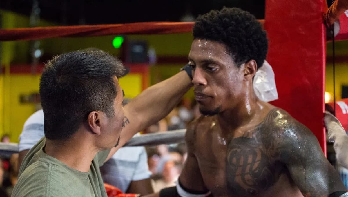 A coach working a fighter's corner between rounds at ringside