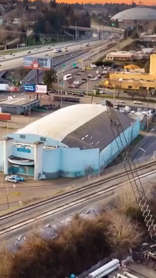 South Sound Martial Arts' arch-roofed building seen from the air, beside Interstate 5 in Tacoma
